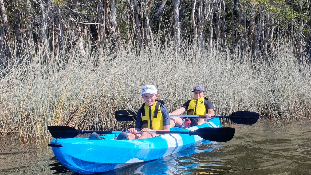 kids paddling a canoe on Sunshine Coast Adventure Mentoring excursion