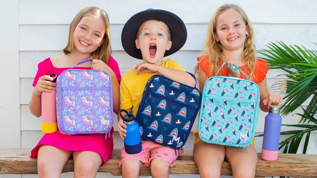 Happy kids with lunchboxes from Coastal Kidswear, Sunshine Coast
