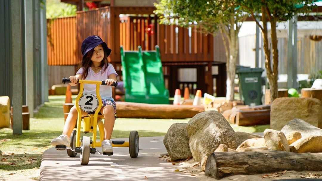 Child riding bike at Sanctuary Early Learning Adventure Buderim