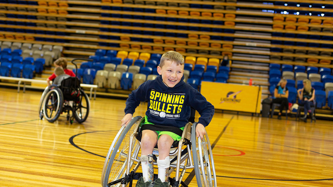 Boy playing wheelchair basketball with Suncoast Spinners, Sunshine Coast